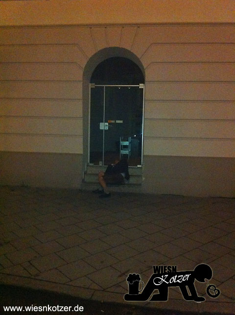 Drunken Guy sleeping in the main entrance of a design agency in Munich