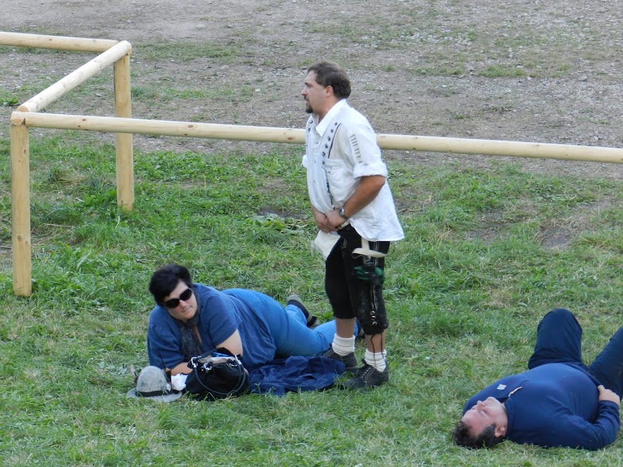 Woman lays in the sun while her husband pulls his peewee out