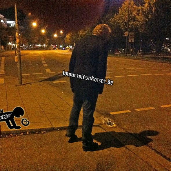 man stumbling over the street at night