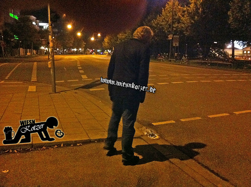 man stumbling over the street at night
